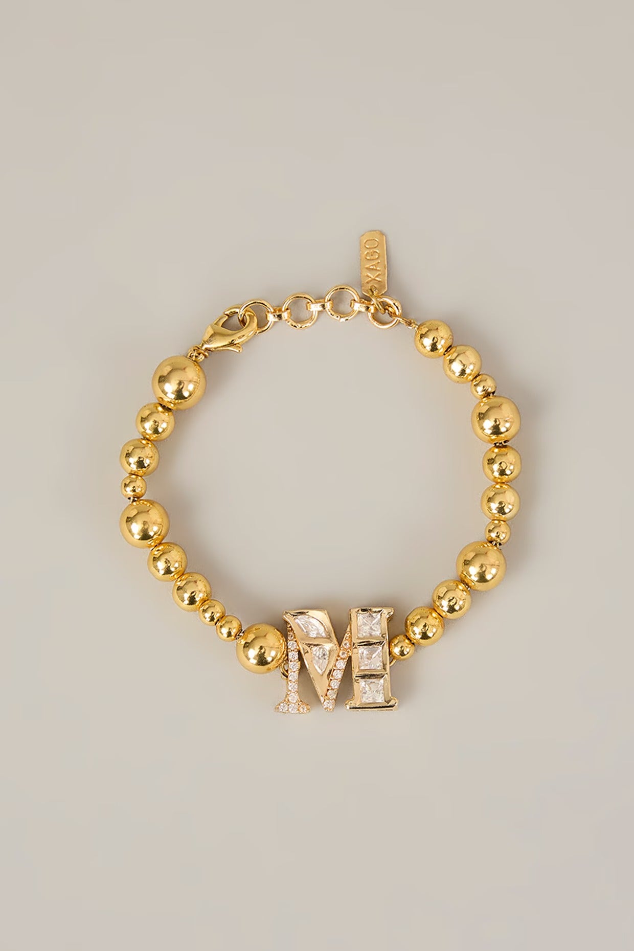 Veer Rakhi – Monogram Rakhi with Gold Beads | XAGO Rakshabandhan Edit designer jewellery in 24K gold plating | XAGO Luxe