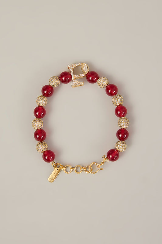 Aarav Rakhi – Polki Monogram Rakhi with Red Beads & Crystal Accents | Rakshabandhan by XAGO designer jewellery in 24K gold plating | XAGO Luxe