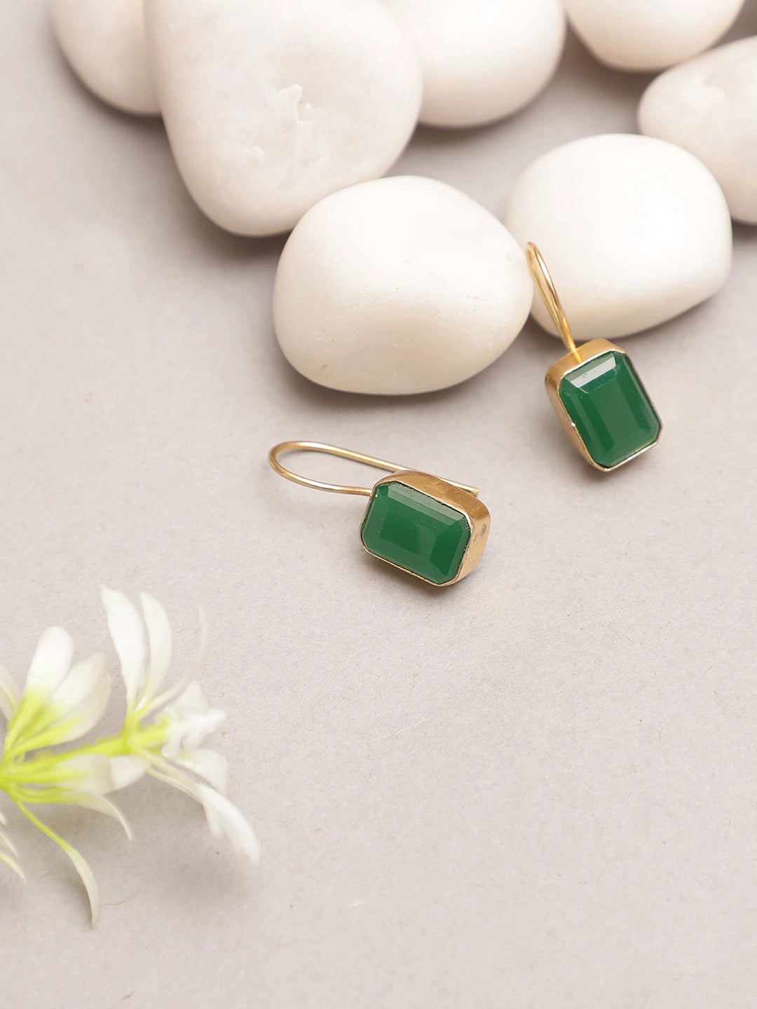 Side view of green onyx gold finish earrings