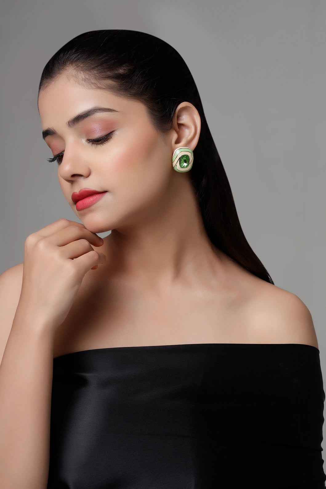 Model wearing verde swirl green crystal stud earrings in side profile