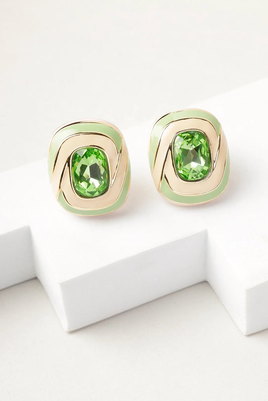 erde swirl stud earrings with green crystal and gold enamel detailing on white background