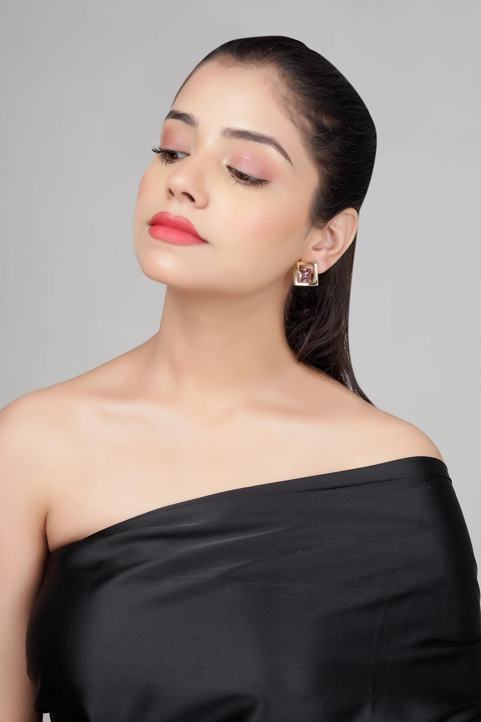 Model wearing Amethyst Prism stud earrings with geometric gold frame