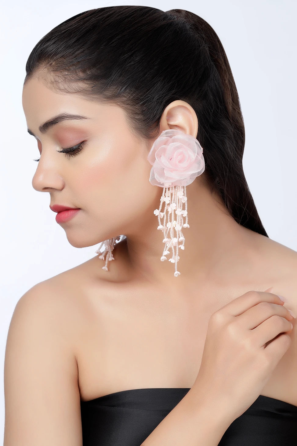 Side profile of model wearing blush cascade floral pearl drop earrings