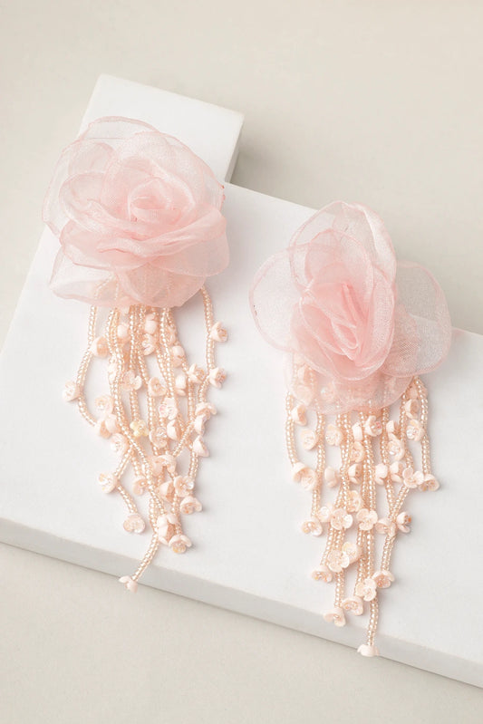 Styled shot of blush cascade pink floral pearl earrings on white blocks