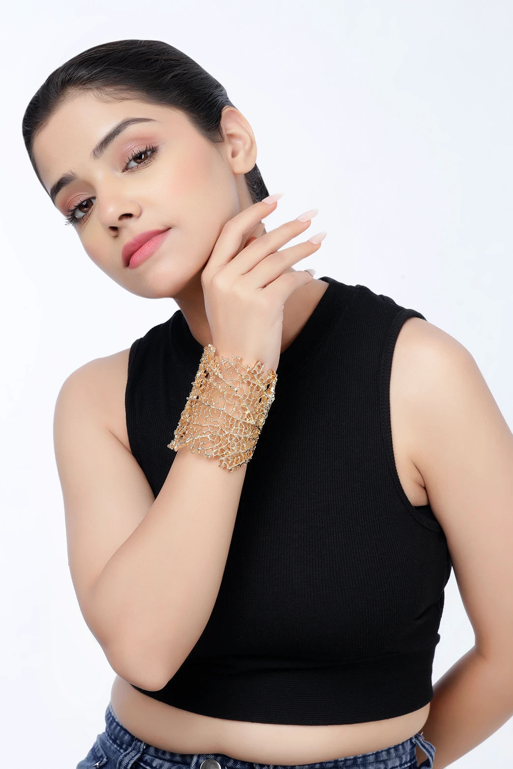 Coral Reef cuff bracelet worn by model in gold finish