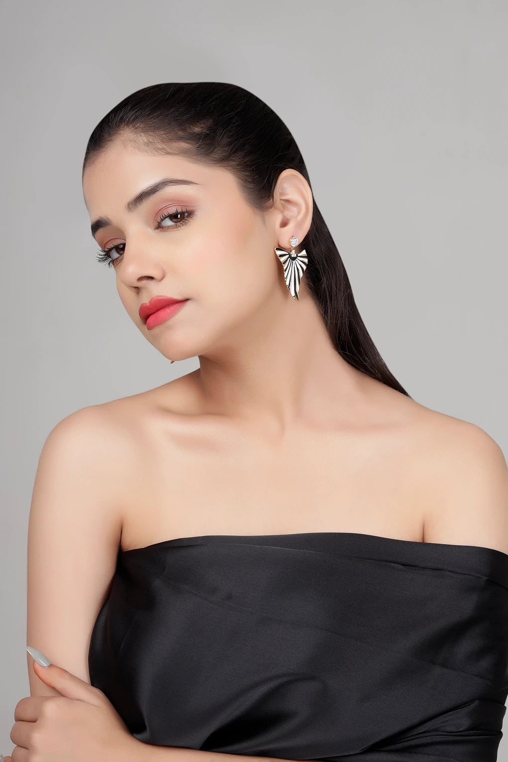 Model wearing Eclipse Fan black and white enamel statement earrings