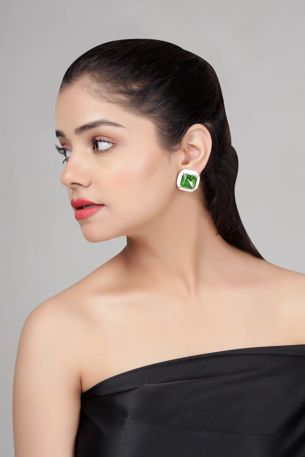 Side view of Emerald Frost stud earrings on model