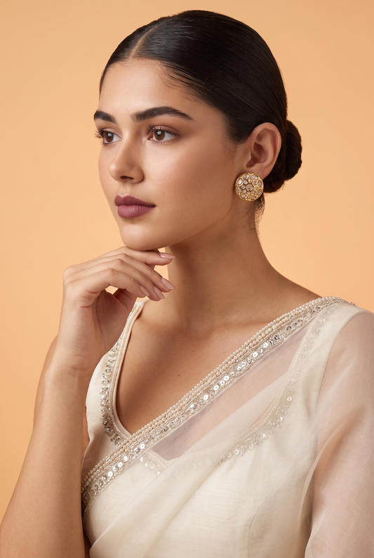 Le Ronit moissanite polki studs worn with an ivory organza saree, sleek low bun