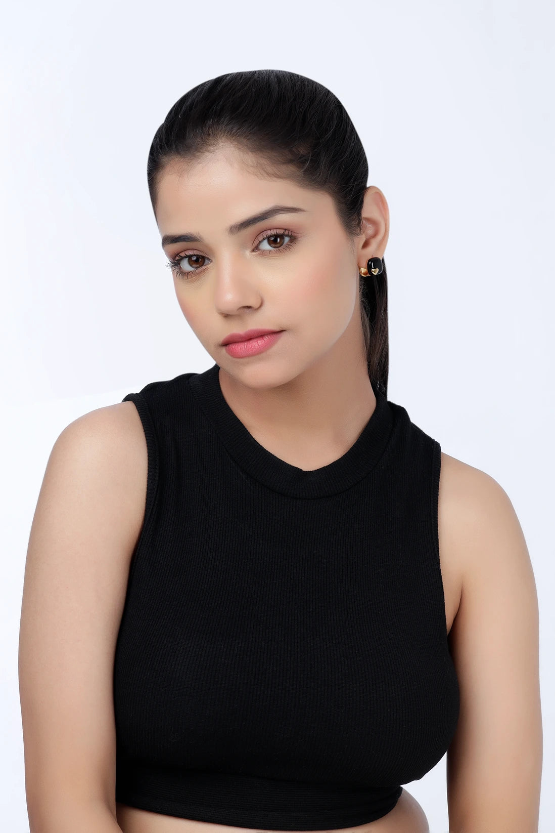 Model wearing Noir Heart black enamel stud earrings