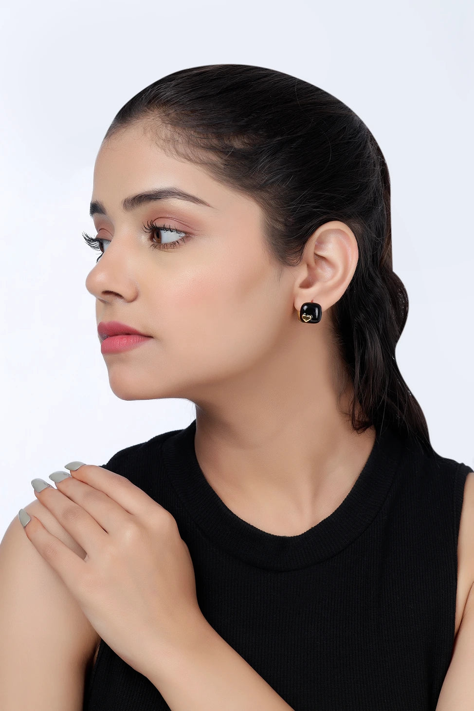 Side view of Noir Heart enamel stud earrings on model