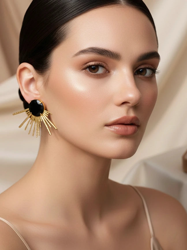Model wearing black onyx gold sunburst statement stud earrings