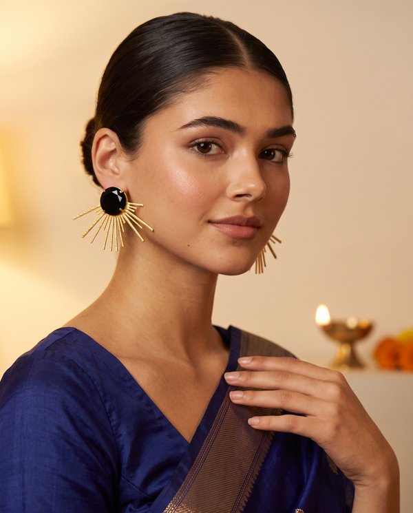 Model in a lapis blue silk saree wearing Noir Solis black onyx sunburst stud earrings