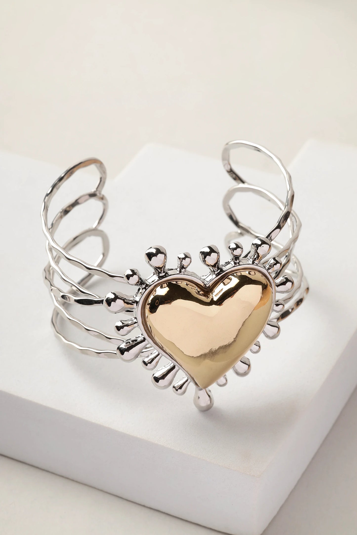 Close-up of Sacred Heart cuff worn on wrist showing heart detail