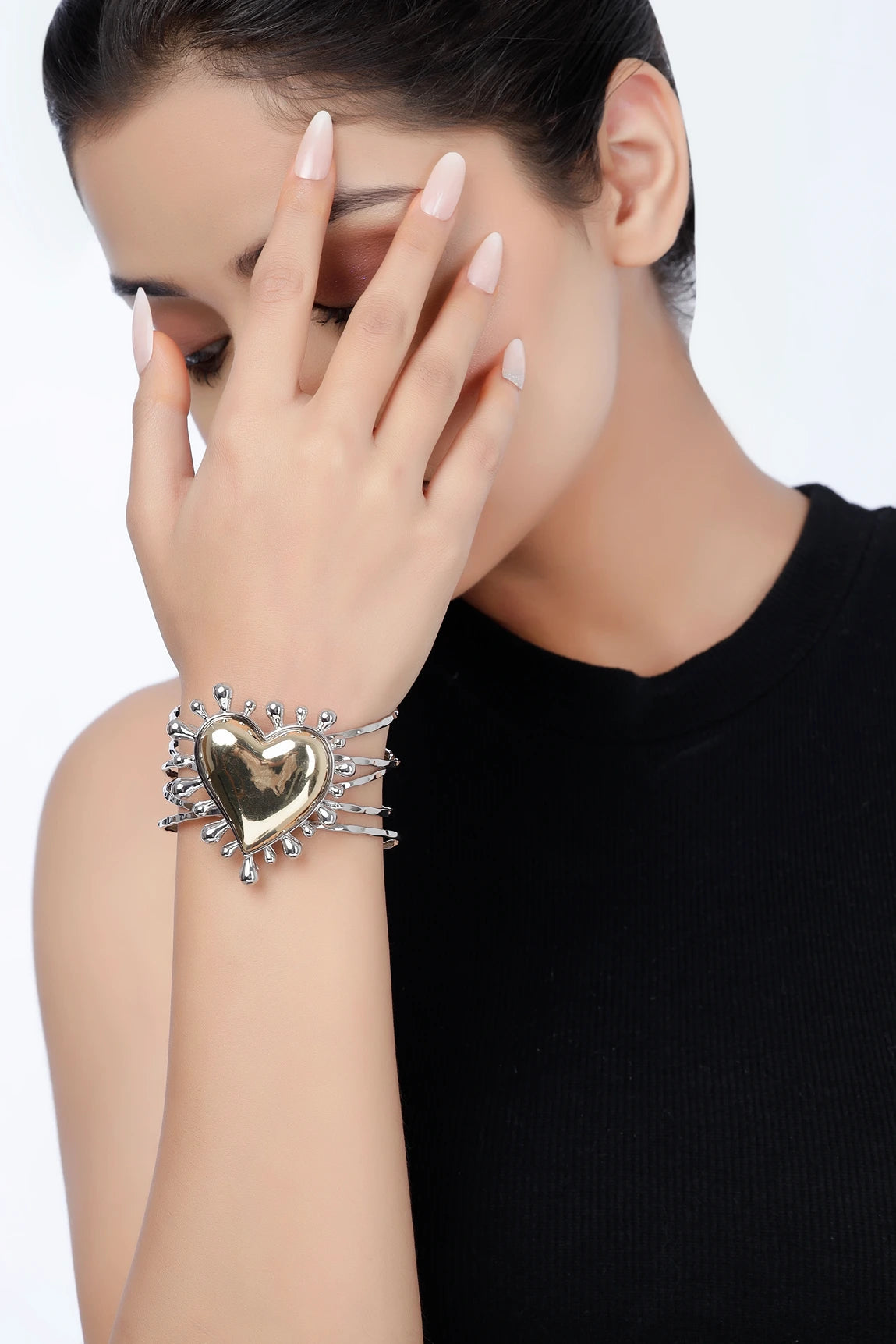 Model wearing Sacred Heart two-tone heart statement cuff bracelet