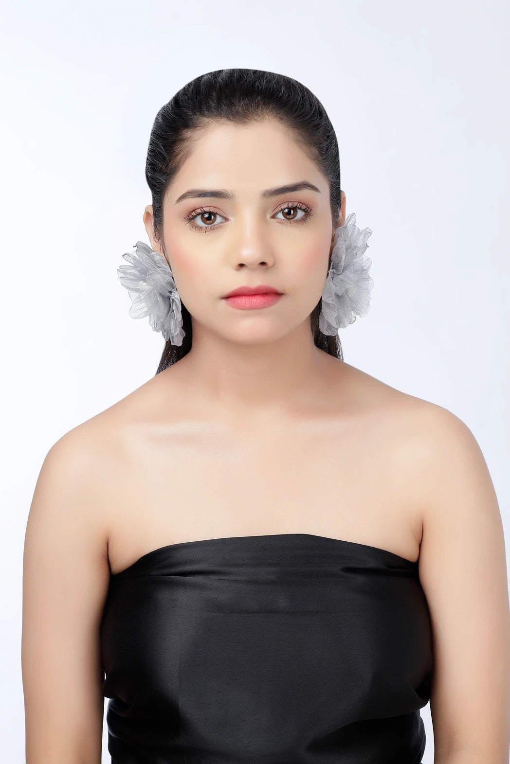 Model wearing silver mist grey organza floral statement earrings front view