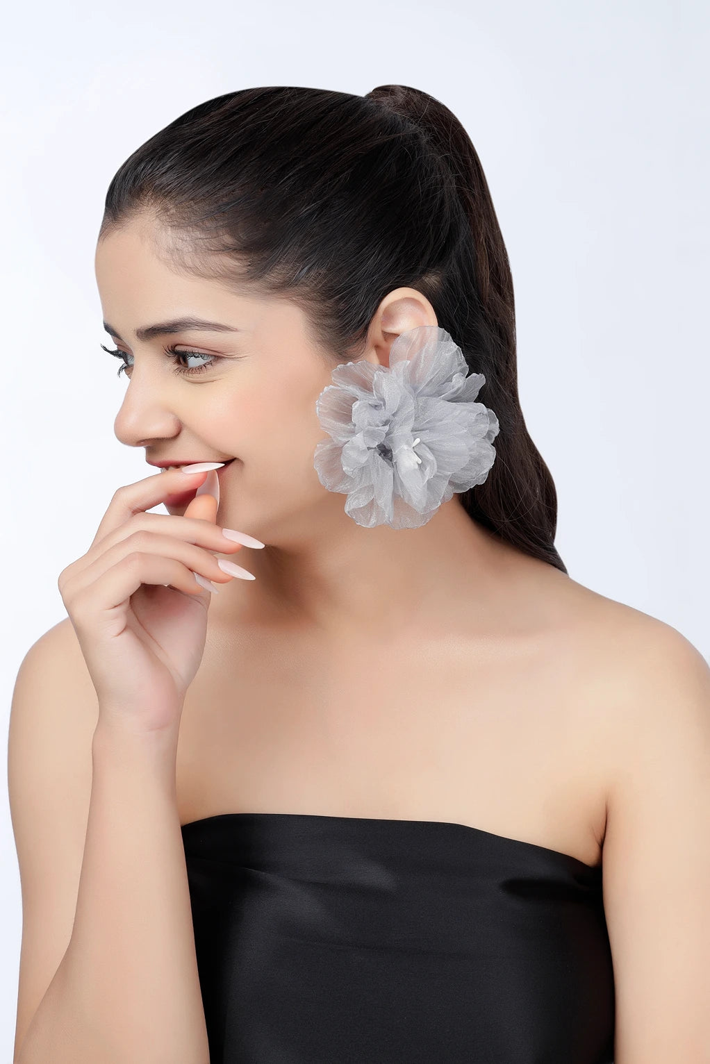 Side profile of model wearing silver mist floral statement earrings